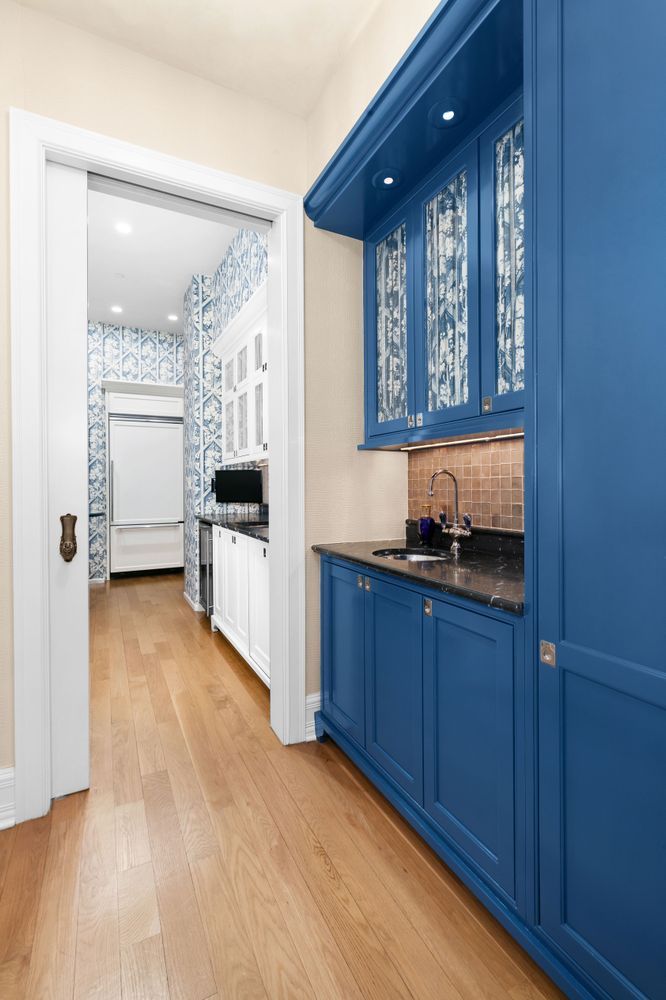 1 Central Park South, Unit 909913 Manhattan, NY 10019 - Photo 23 of 38 a view of a kitchen cabinets and a wooden floor