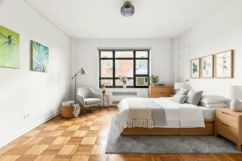 a bedroom with a large bed and a window