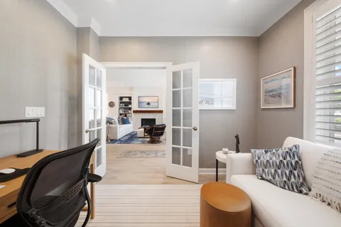 a living room with furniture and a wooden floor