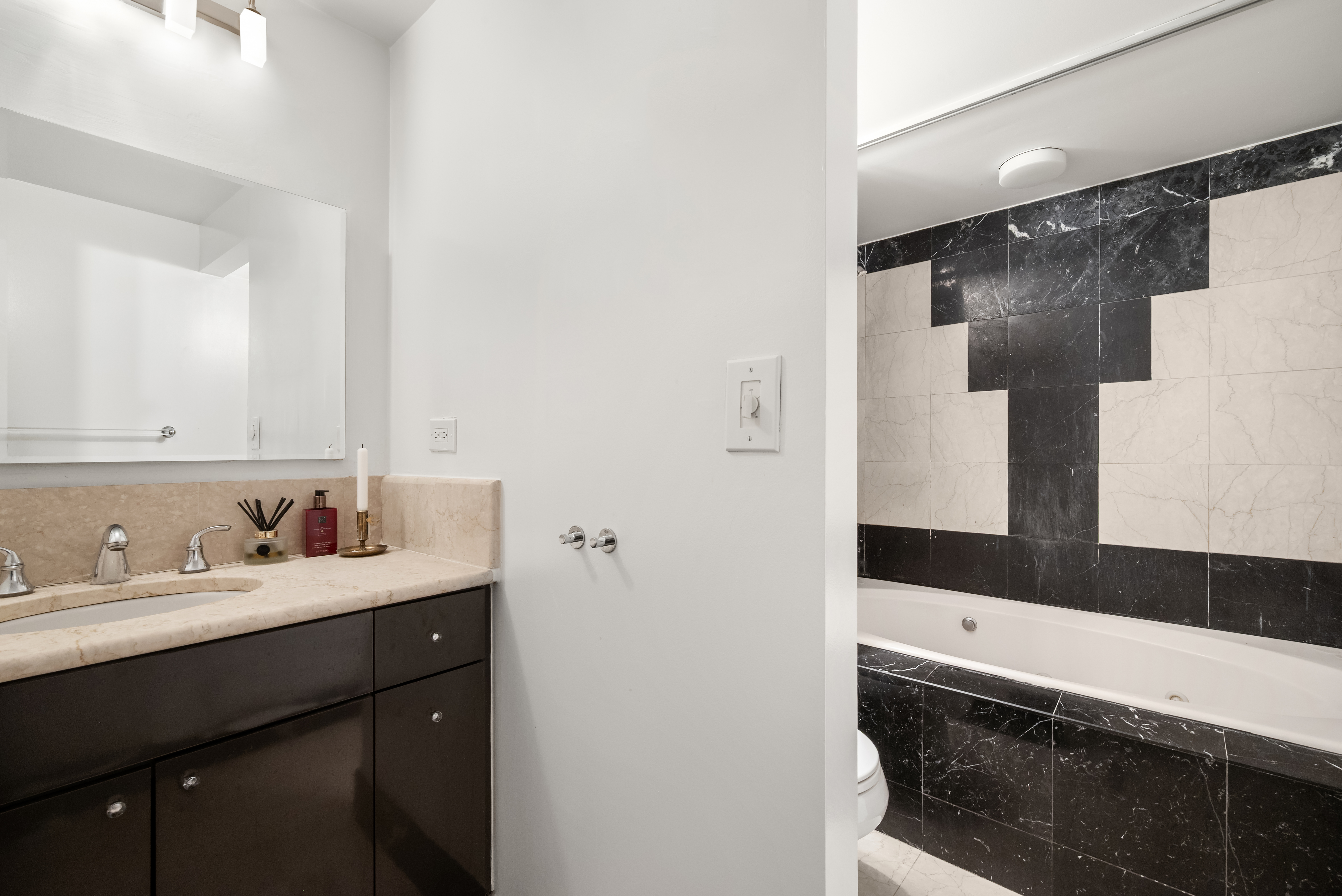 43 West 61st Street, Unit 24Y Manhattan, NY 10023 - Photo 4 of 6 a bathroom with a sink and a mirror