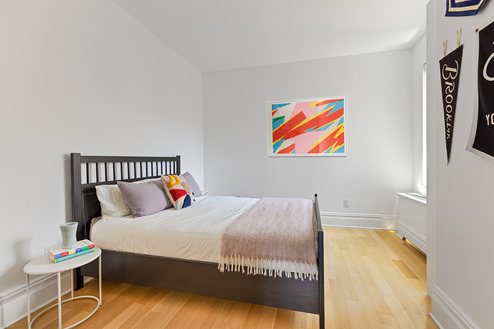 225 Eastern Parkway, Unit 6C Brooklyn, NY 11238 - Photo 6 of 12 a bed sitting in a bedroom next to a small yard
