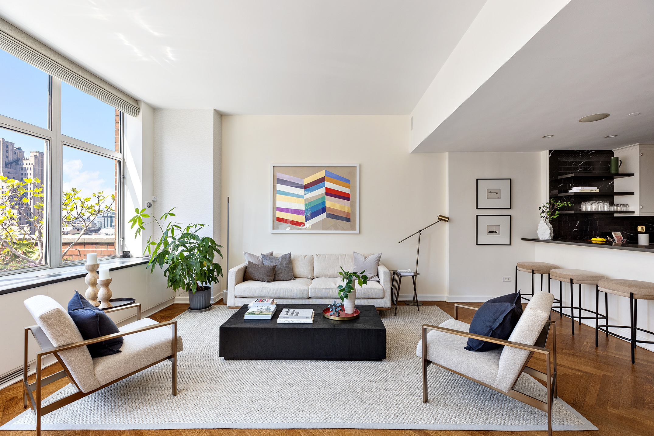 201 West 17th Street, Unit PHF Manhattan, NY 10011 - Photo 3 of 22 a living room with furniture and paintings on the wall next to a window