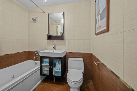 a bathroom with a toilet sink and mirror