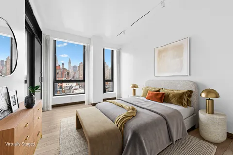 a bedroom with a large bed and a large window