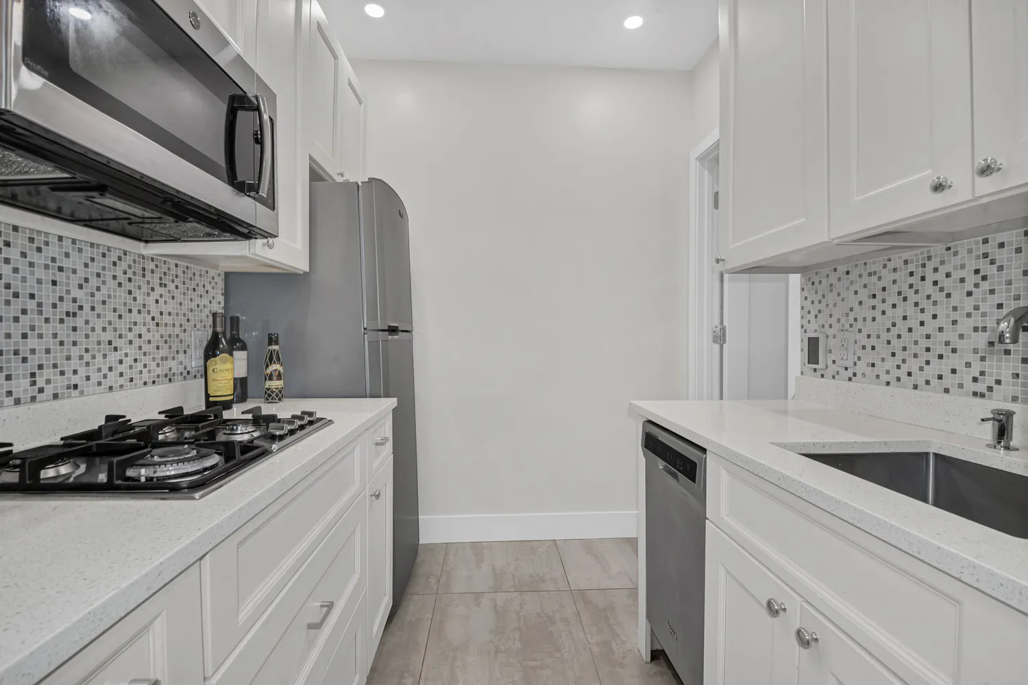 a kitchen with stainless steel appliances granite countertop a sink stove and cabinets