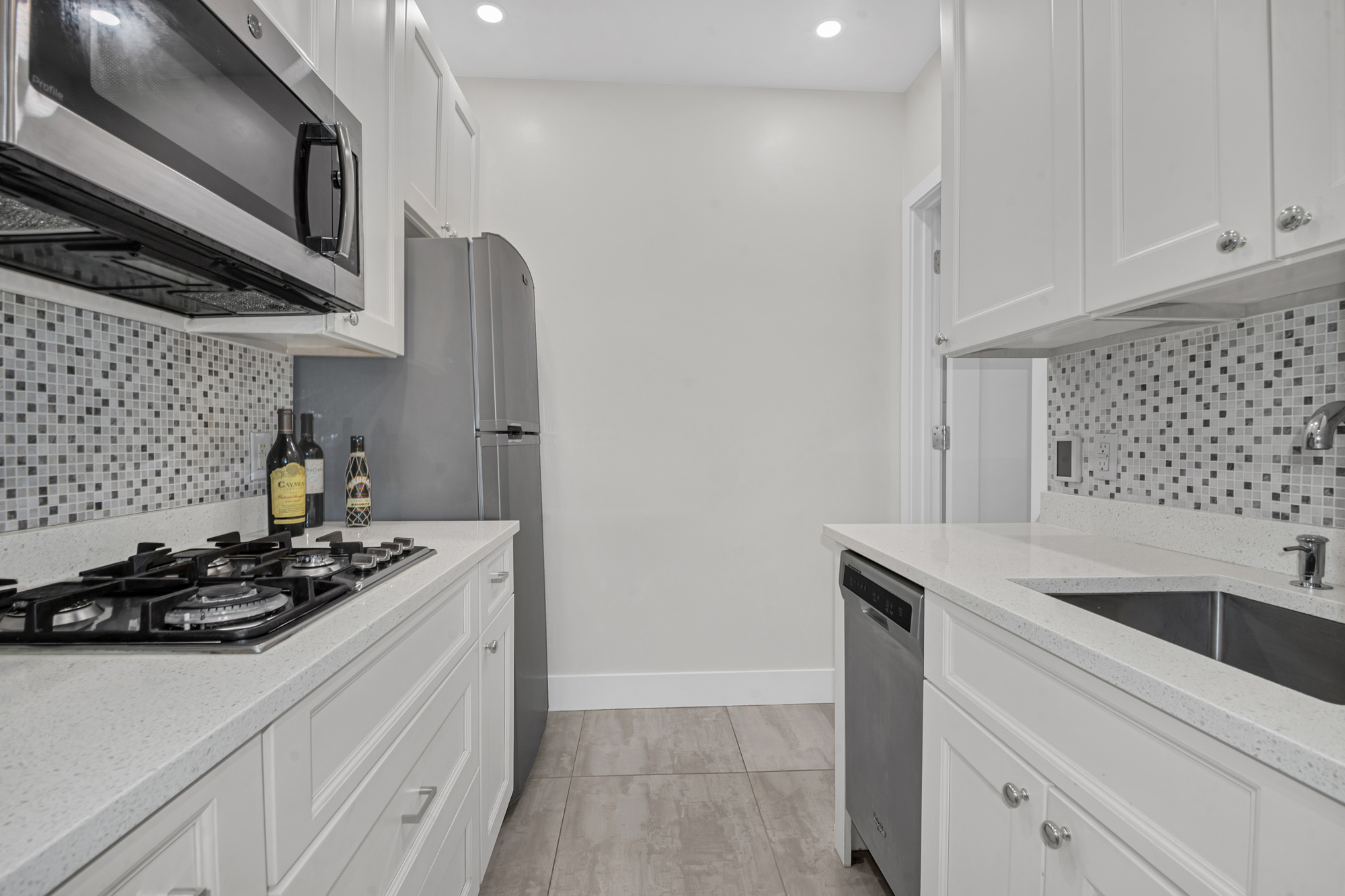244 Riverside Drive, Unit 5K Manhattan, NY 10025 - Photo 4 of 8 a kitchen with stainless steel appliances granite countertop a sink stove and cabinets