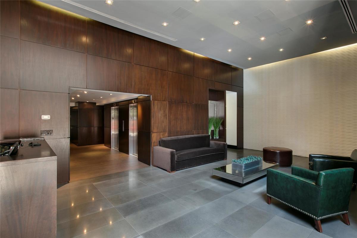 254 Park Avenue South, Unit 3G Manhattan, NY 10010 - Photo 6 of 12 a living room with furniture and a chandelier