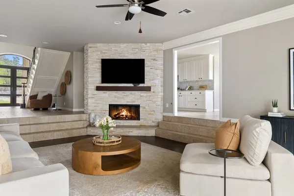 a living room with furniture fireplace and flat screen tv