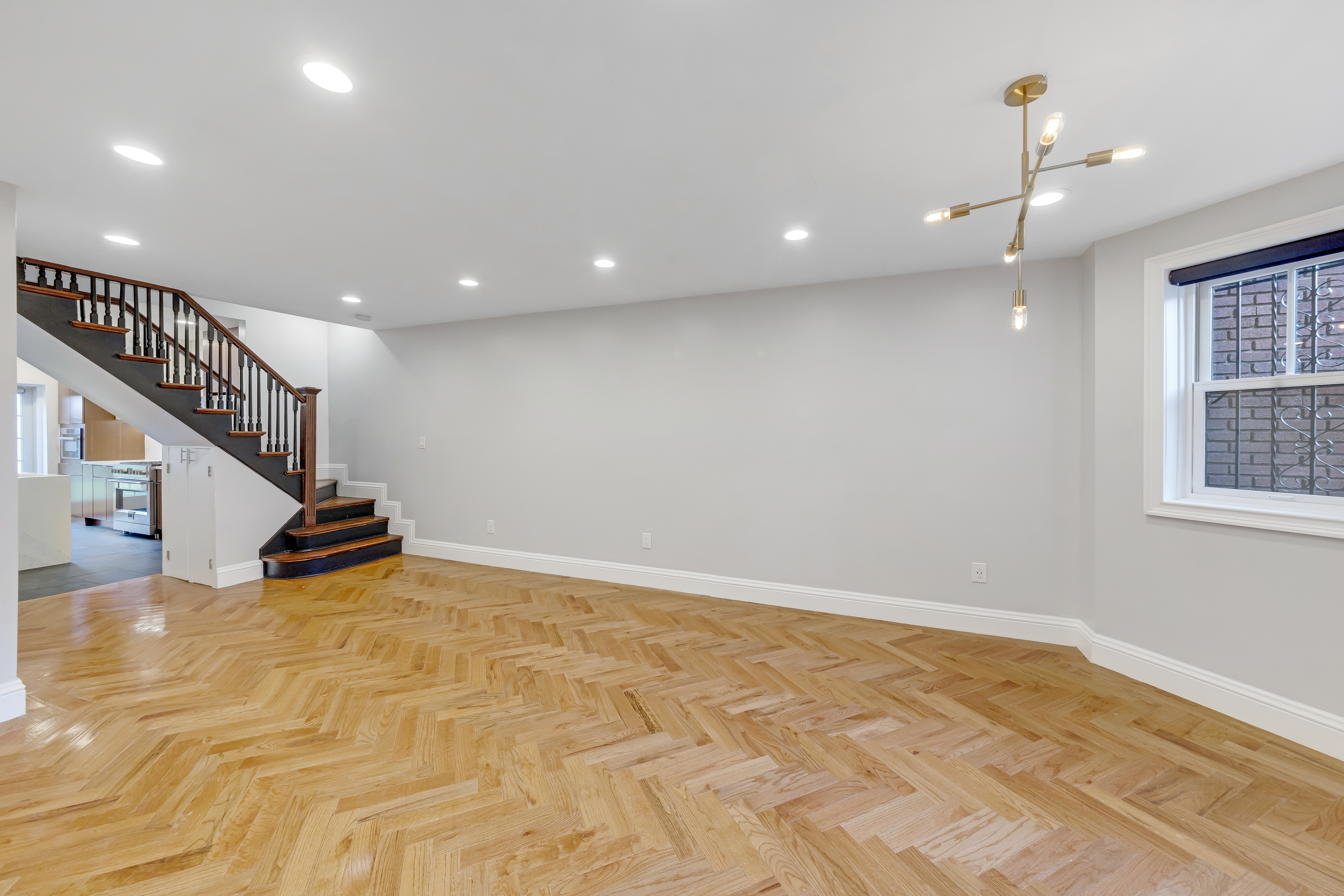 57 Hendrix Street, Unit 1 Brooklyn, NY 11207 - Photo 2 of 12 a view of an empty room with windows & ceiling fan