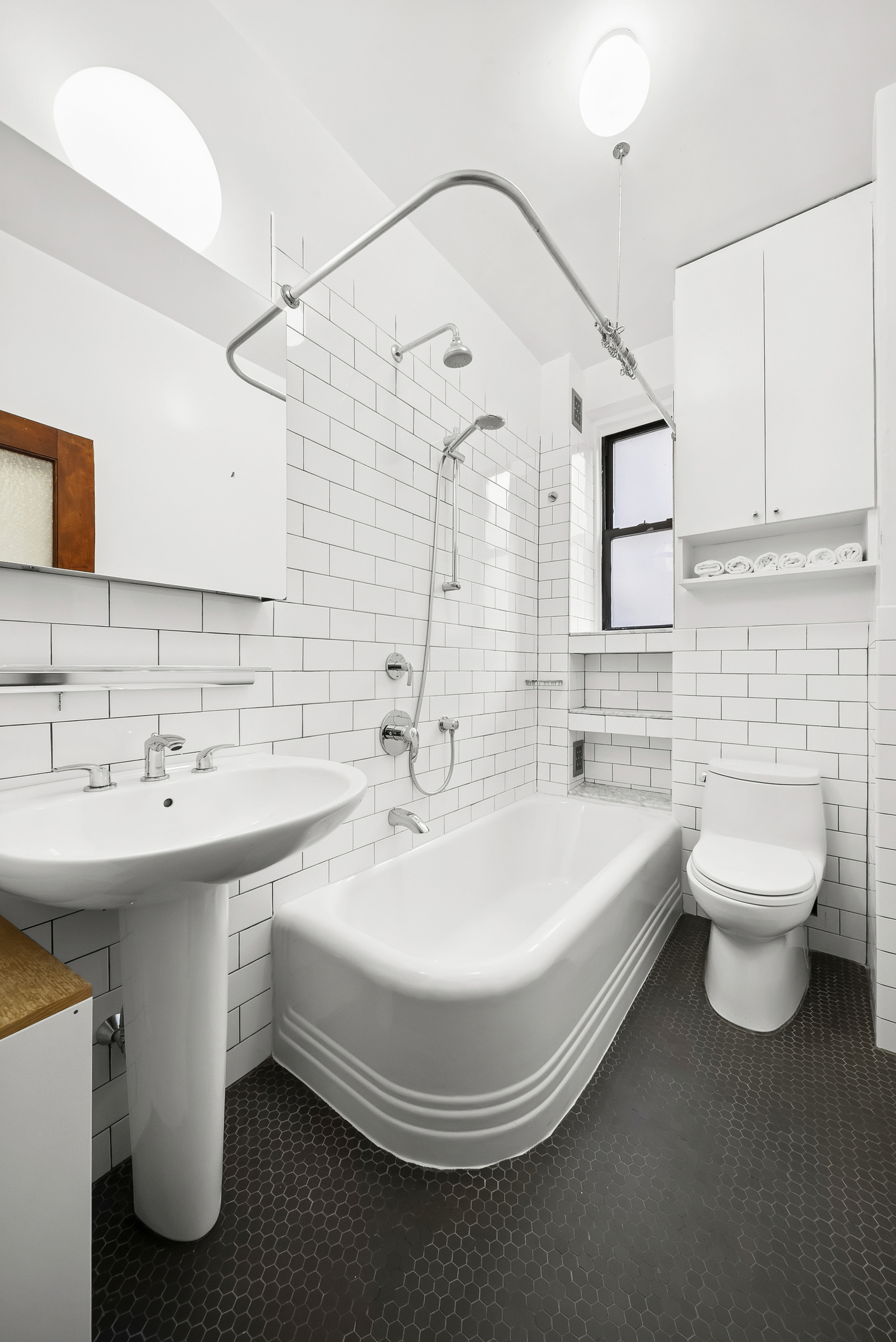536 West 111th Street, Unit 66 Manhattan, NY 10025 - Photo 5 of 8 a spacious bathroom with a double vanity sink mirror and toilet