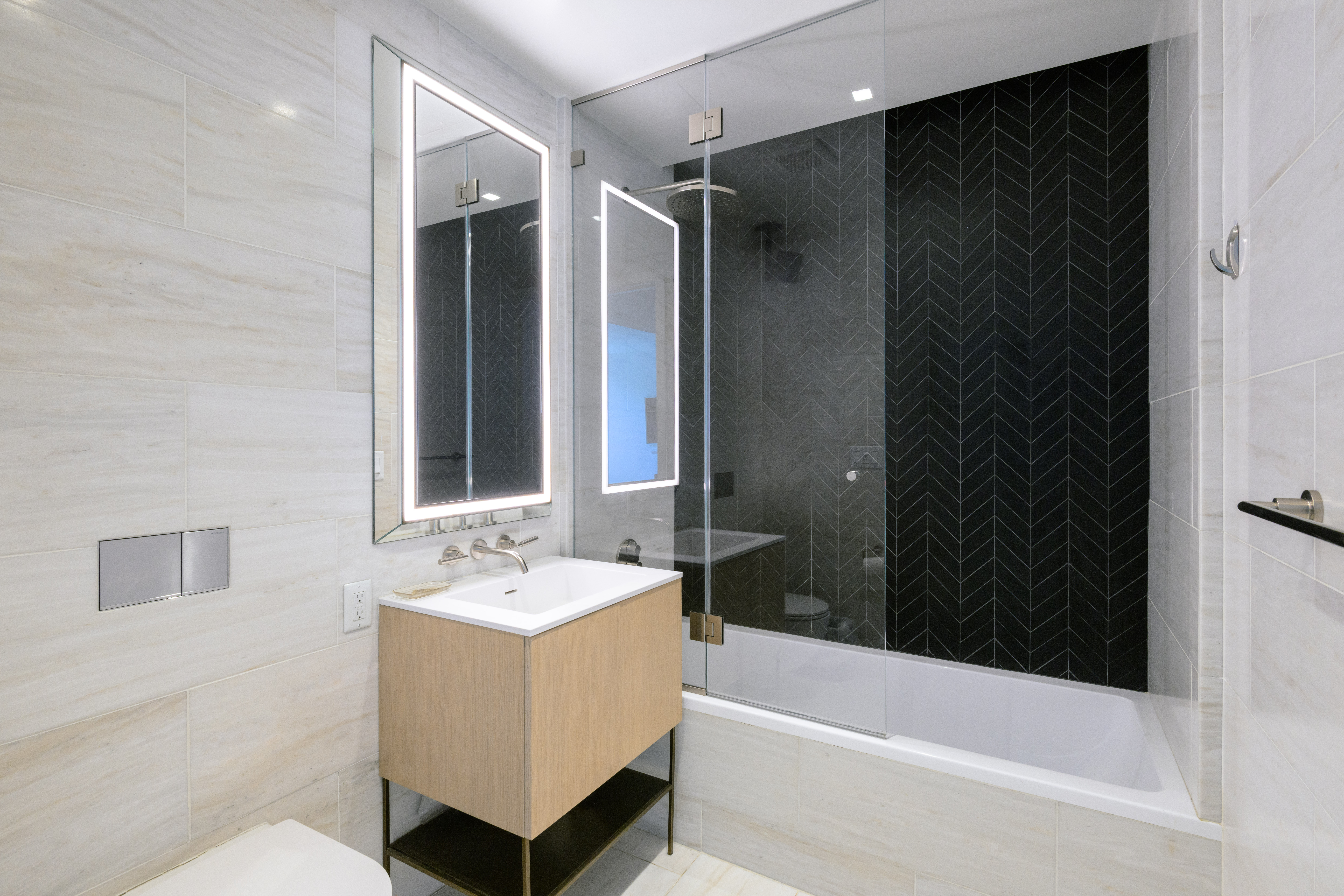 215 West 28th Street, Unit 4E Manhattan, NY 10001 - Photo 4 of 13 a bathroom with a bathtub a shower a sink and a window