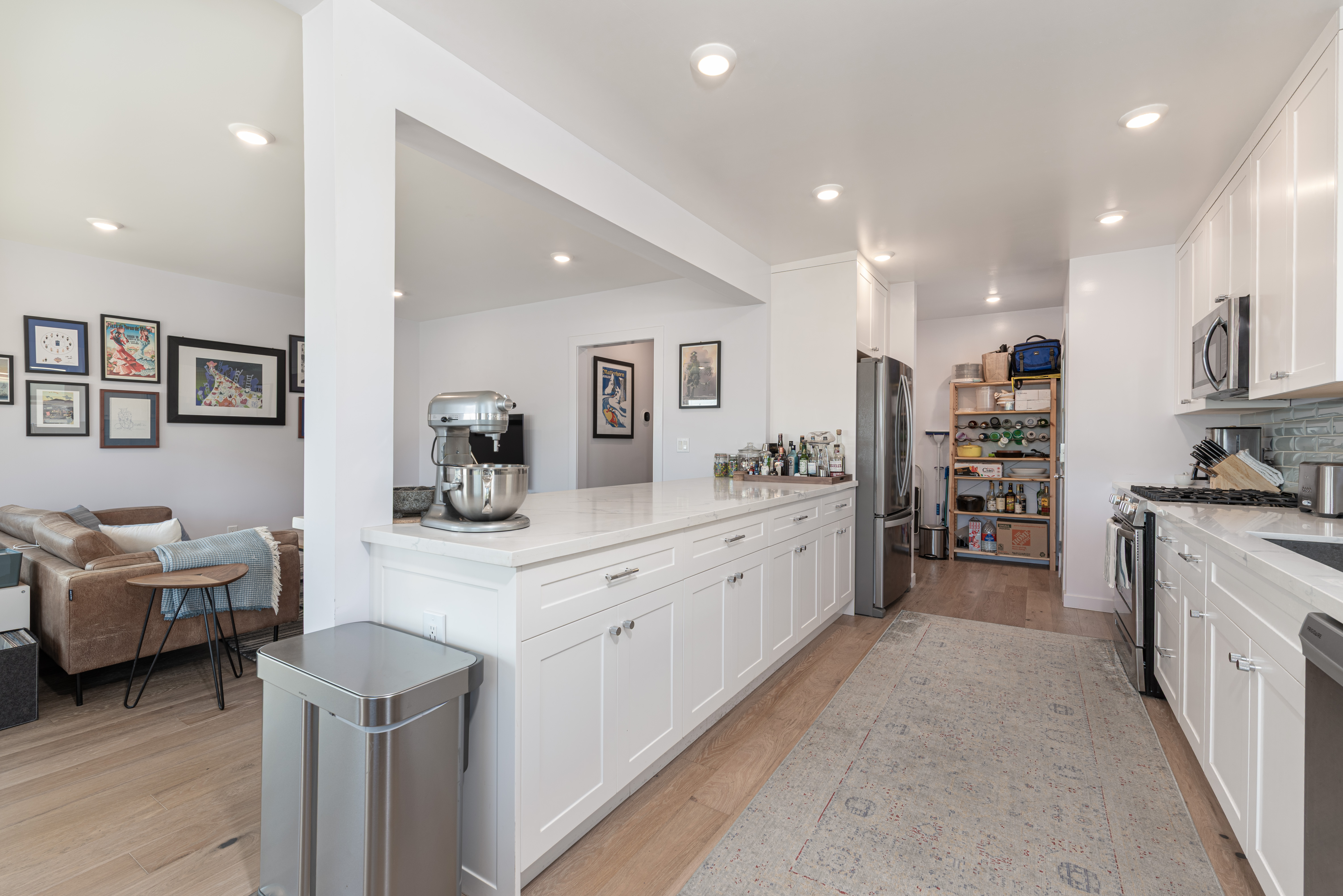 1005 Alexandria Avenue Los Angeles, CA 90029 - Photo 8 of 21 a kitchen that has a lot of cabinets in it and wooden floors