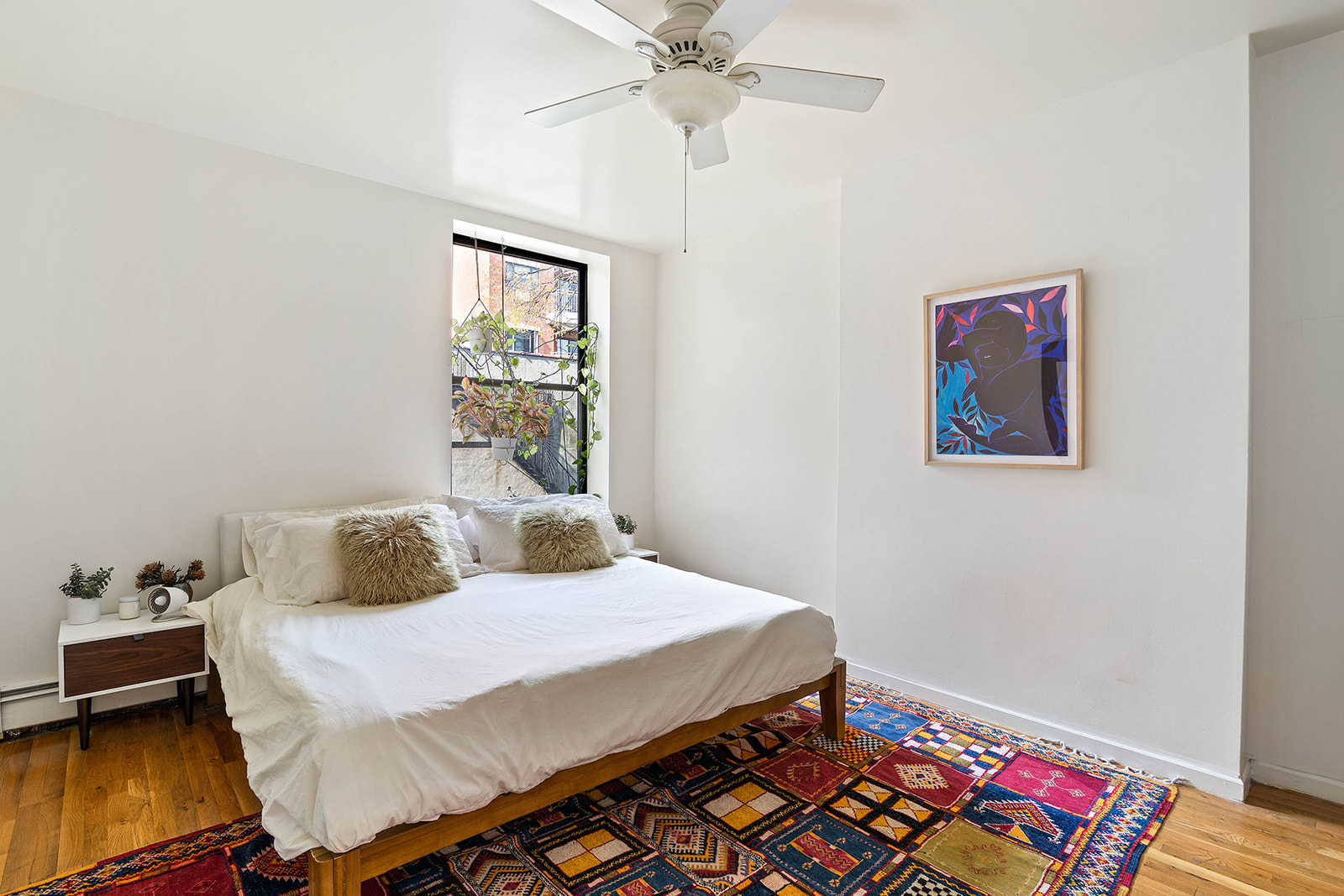 530 West 148th Street Manhattan, NY 10031 - Photo 8 of 14 a bedroom with a bed and wooden floor
