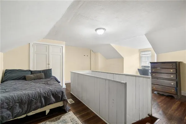 a bedroom with a bed and cabinet