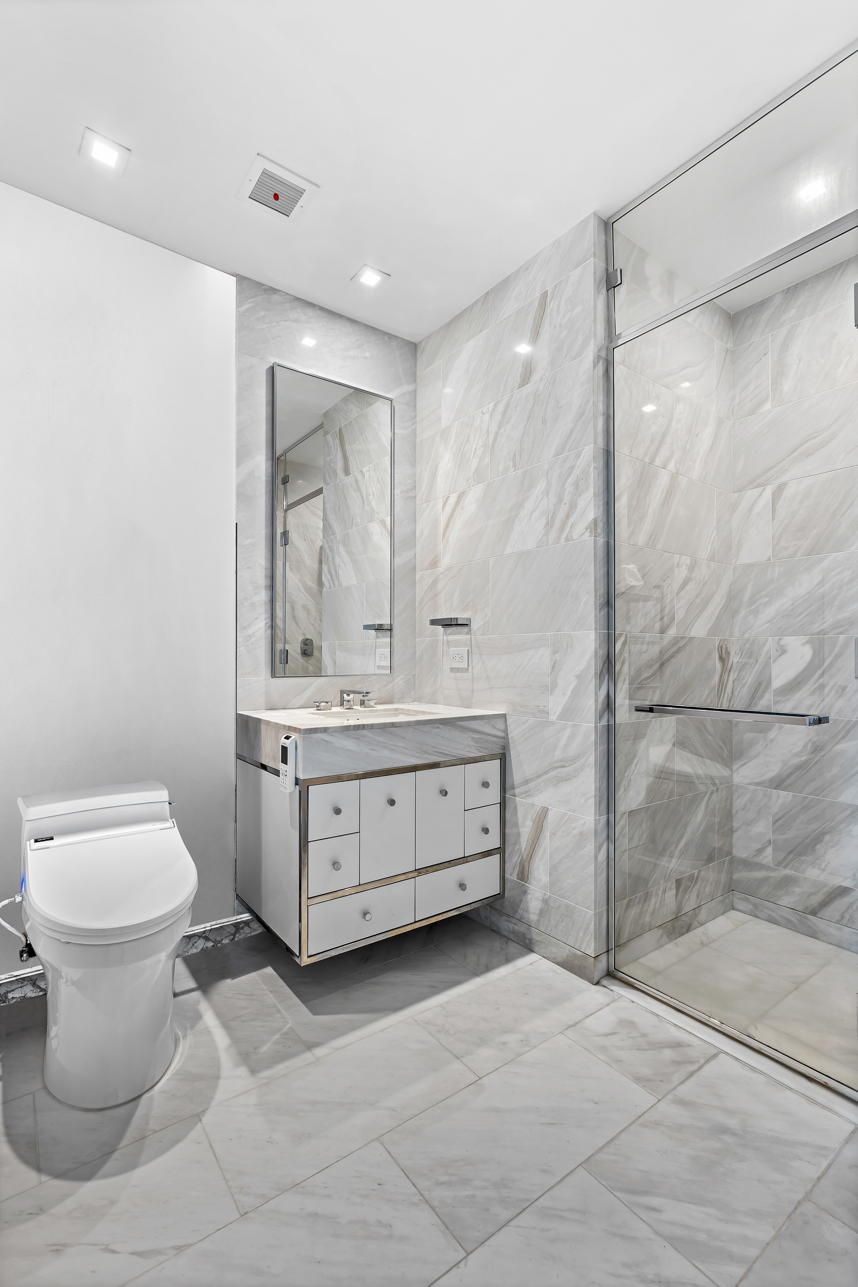 138 East 50th Street, Unit 40B Manhattan, NY 10022 - Photo 10 of 22 a bathroom with a sink toilet and shower