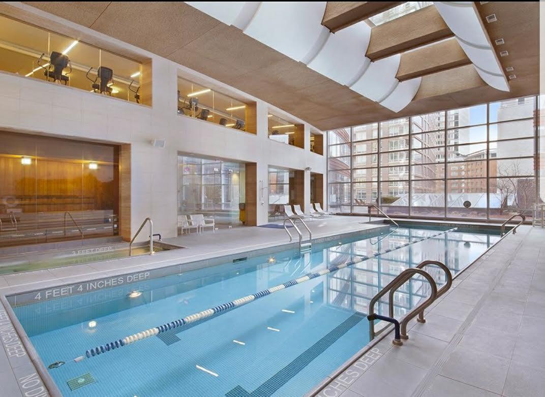 70 Little West Street, Unit 14B Manhattan, NY 10004 - Photo 9 of 17 a view of a swimming pool with outdoor seating