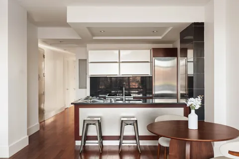 a kitchen with a table and chairs