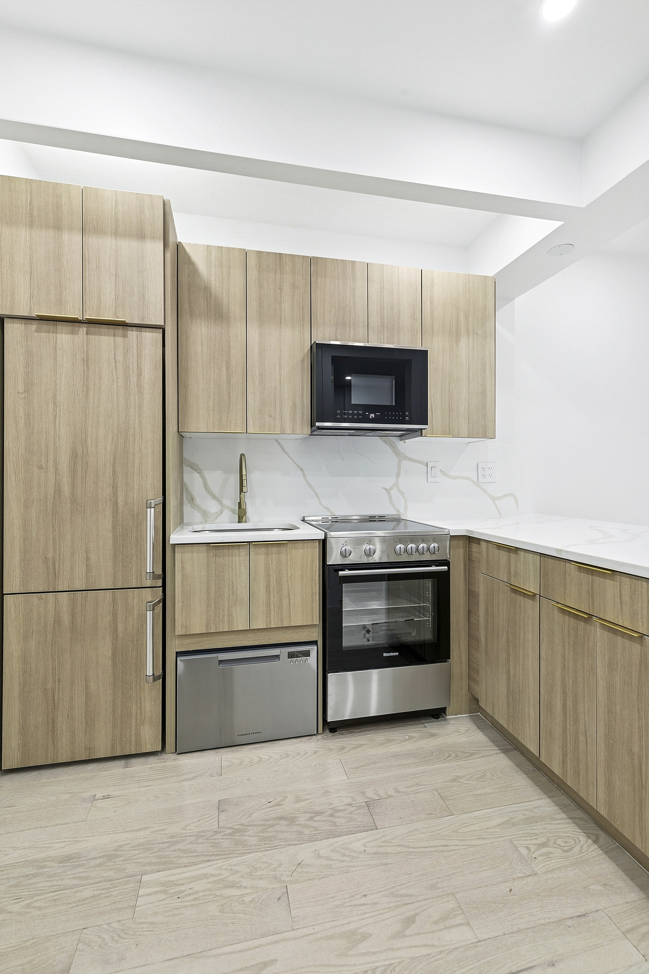 472 Bergen Street, Unit 2R Brooklyn, NY 11217 - Photo 6 of 9 a kitchen with granite countertop a refrigerator and a microwave