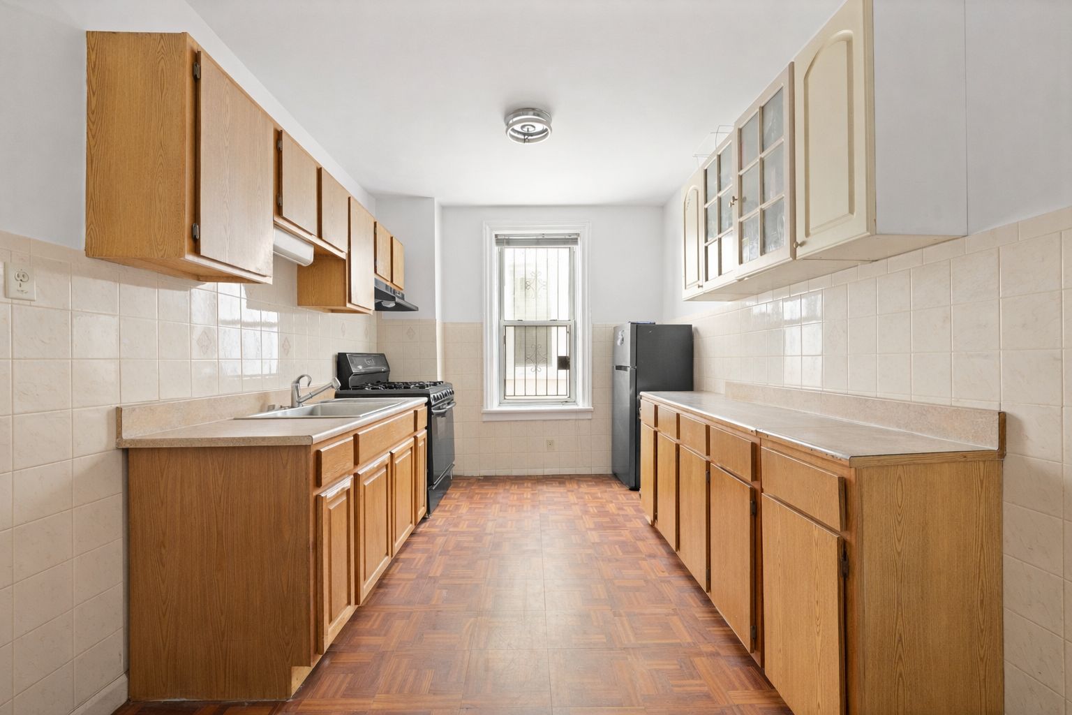 742 44th Street Brooklyn, NY 11220 - Photo 17 of 23 a kitchen with stainless steel appliances a sink and a stove