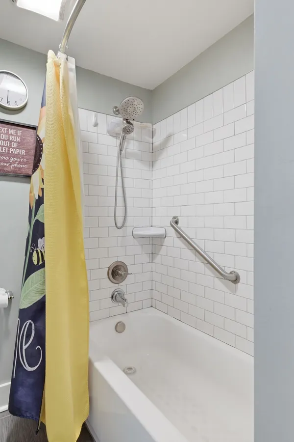 a bathroom with a bathtub and a shower
