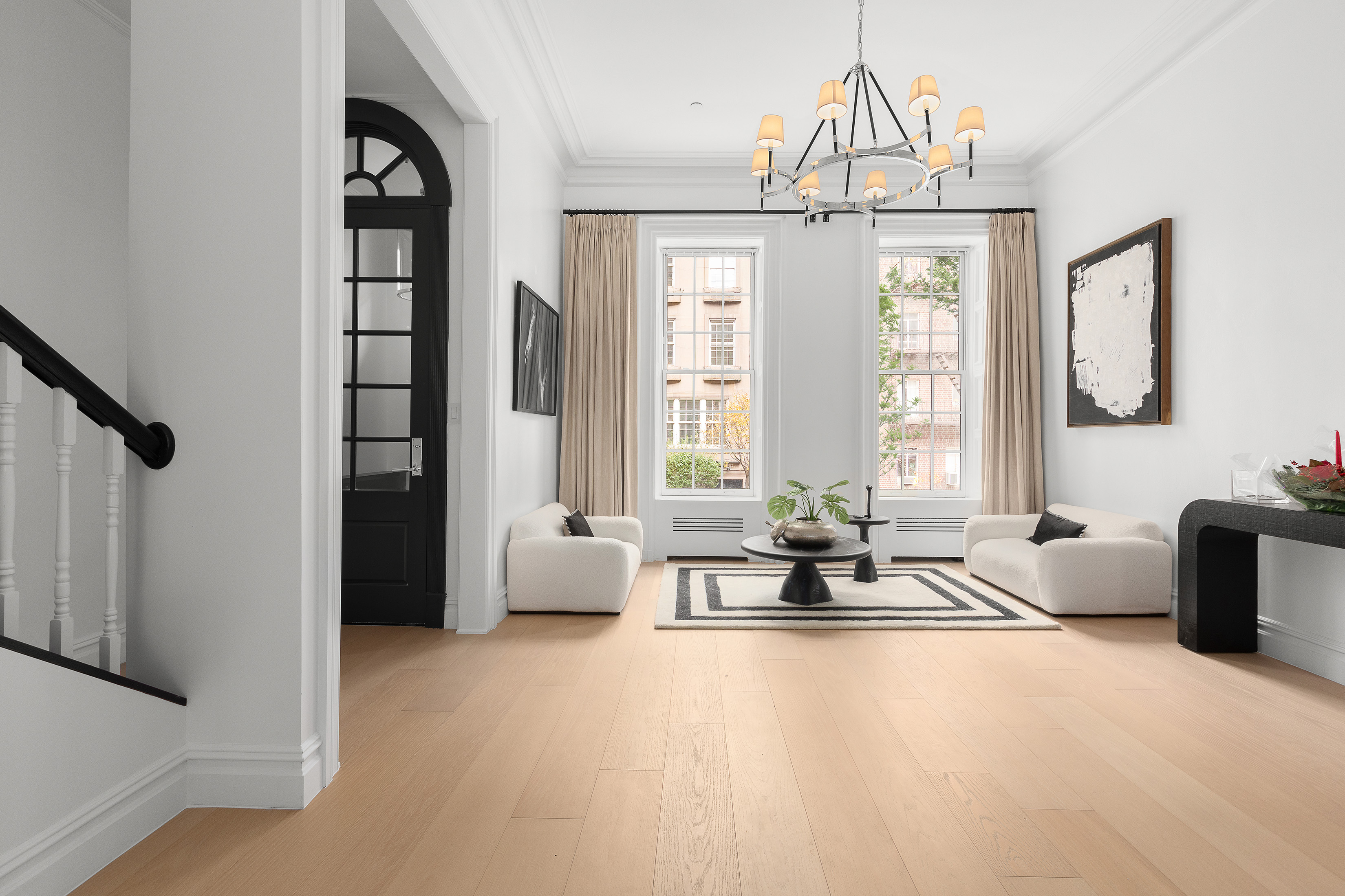 222 East 61st Street Manhattan, NY 10065 - Photo 3 of 30 a living room with furniture and large windows