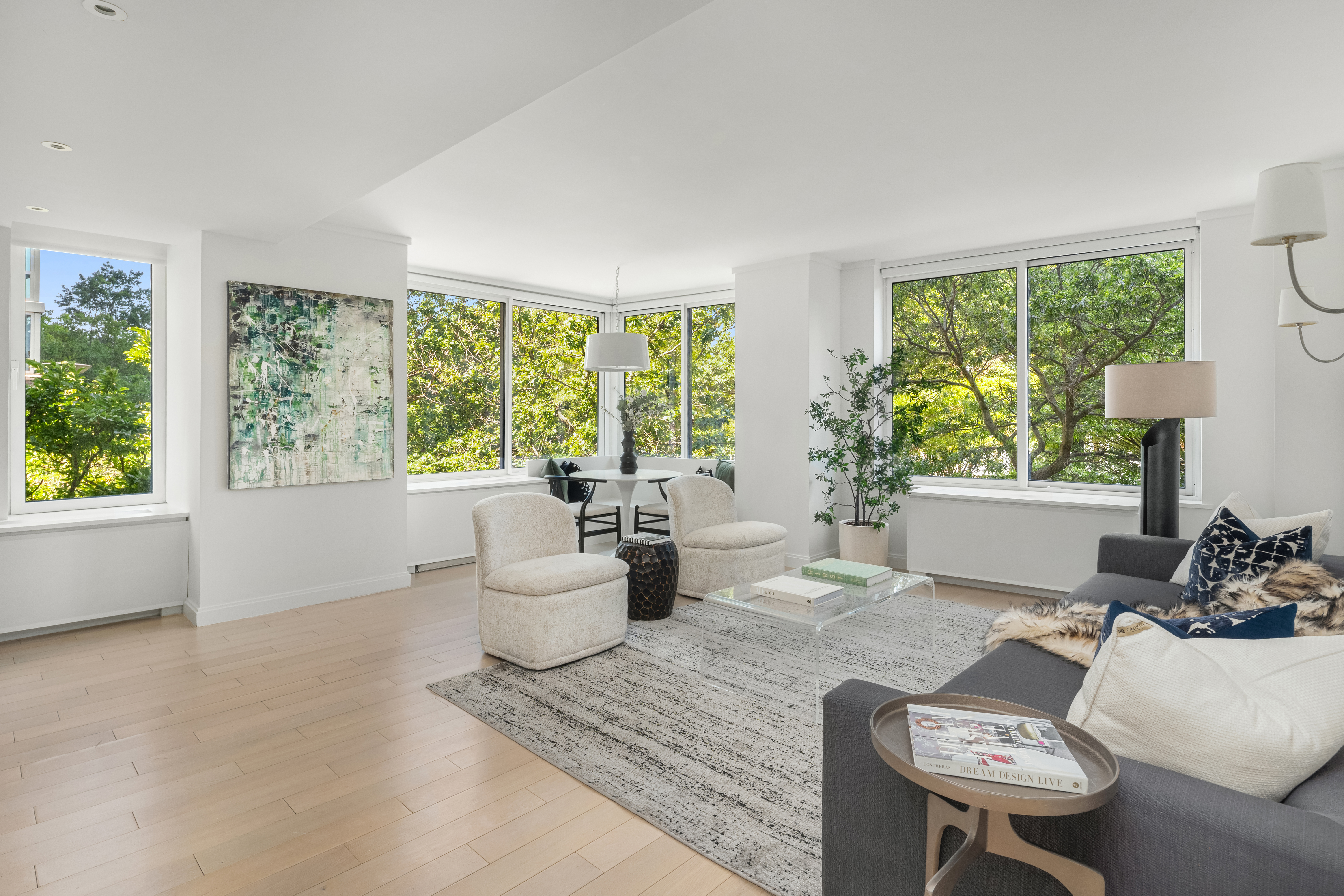 212 Warren Street, Unit 2C Manhattan, NY 10282 - Photo 2 of 21 a living room with furniture and a large window