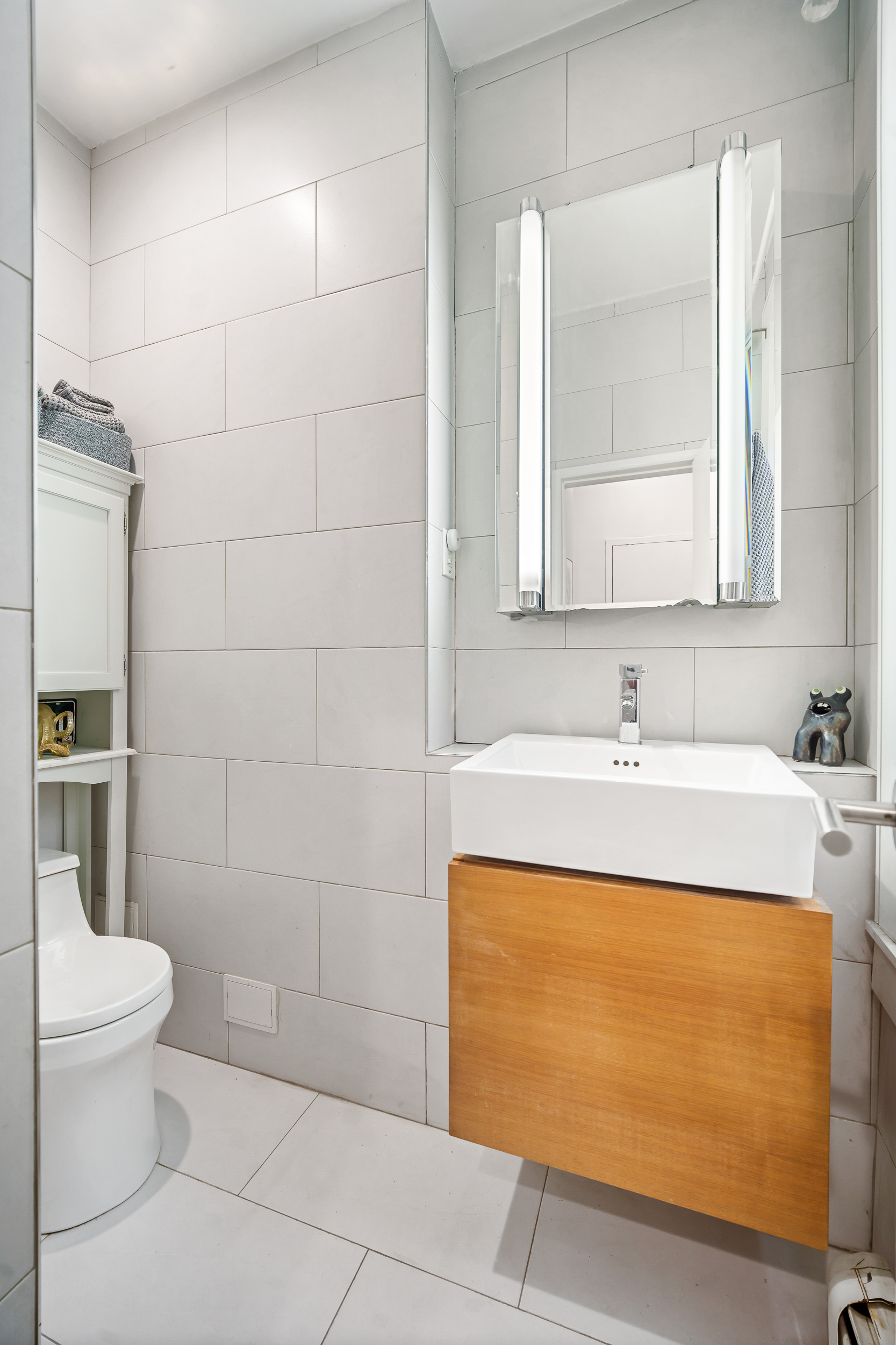 330 West 17th Street, Unit 3E Manhattan, NY 10011 - Photo 6 of 8 a bathroom with a sink a toilet and shower