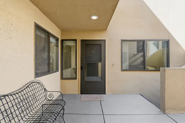 a kitchen with kitchen island a dining table chairs stainless steel appliances and cabinets