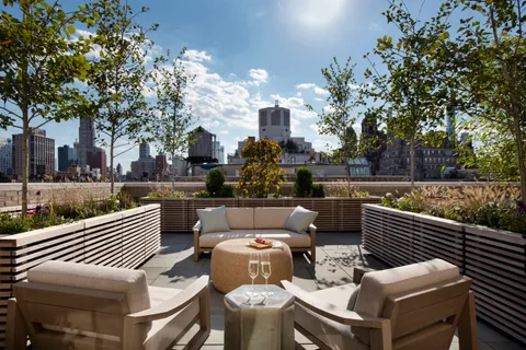 a view of a patio with couches table and chairs and potted plants
