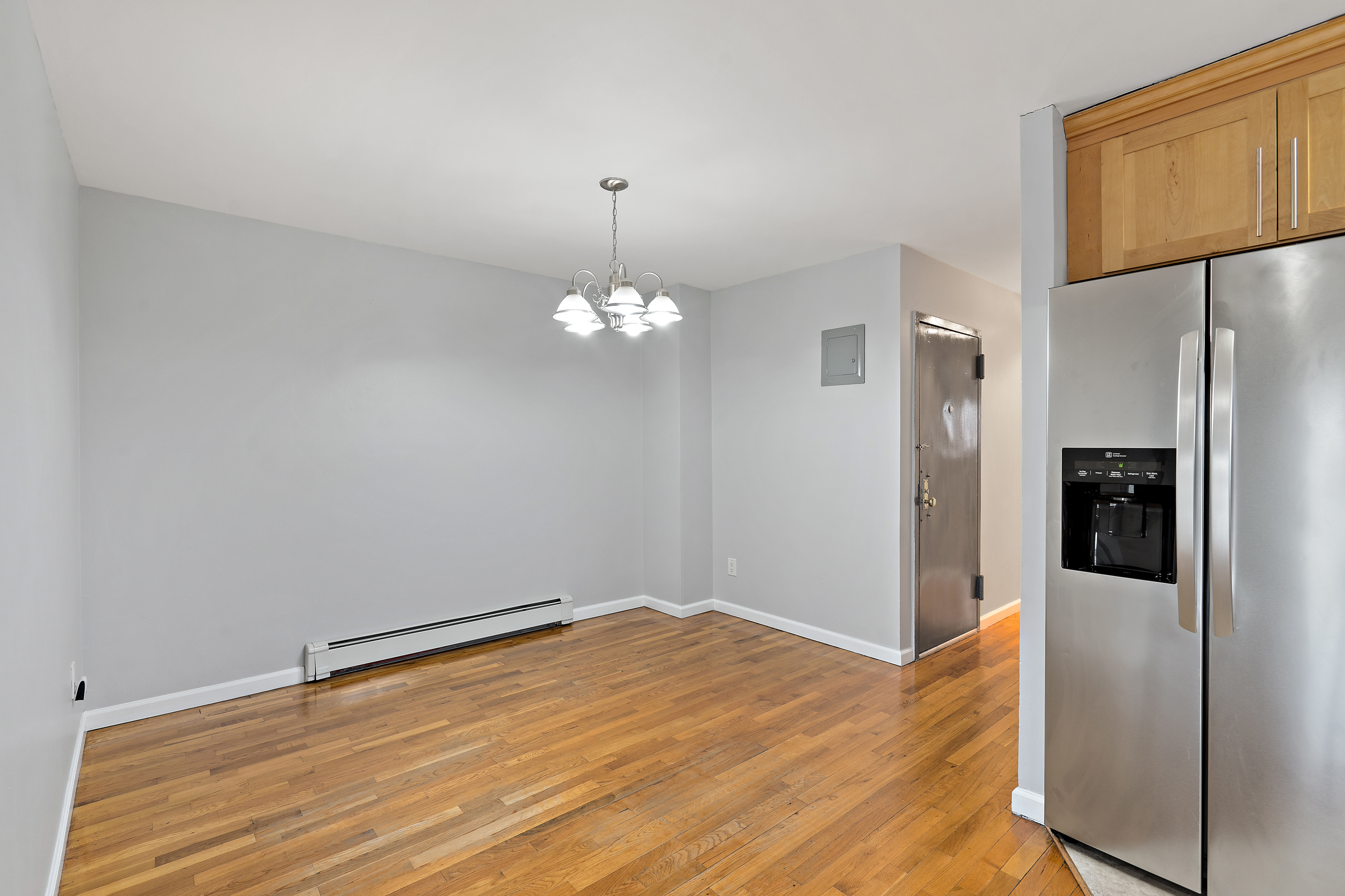 3230 Johnson Avenue, Unit 3 Bronx, NY 10463 - Photo 6 of 21 a view of a kitchen with wooden floor and a refrigerator