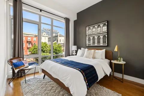 a bedroom with a bed and a window