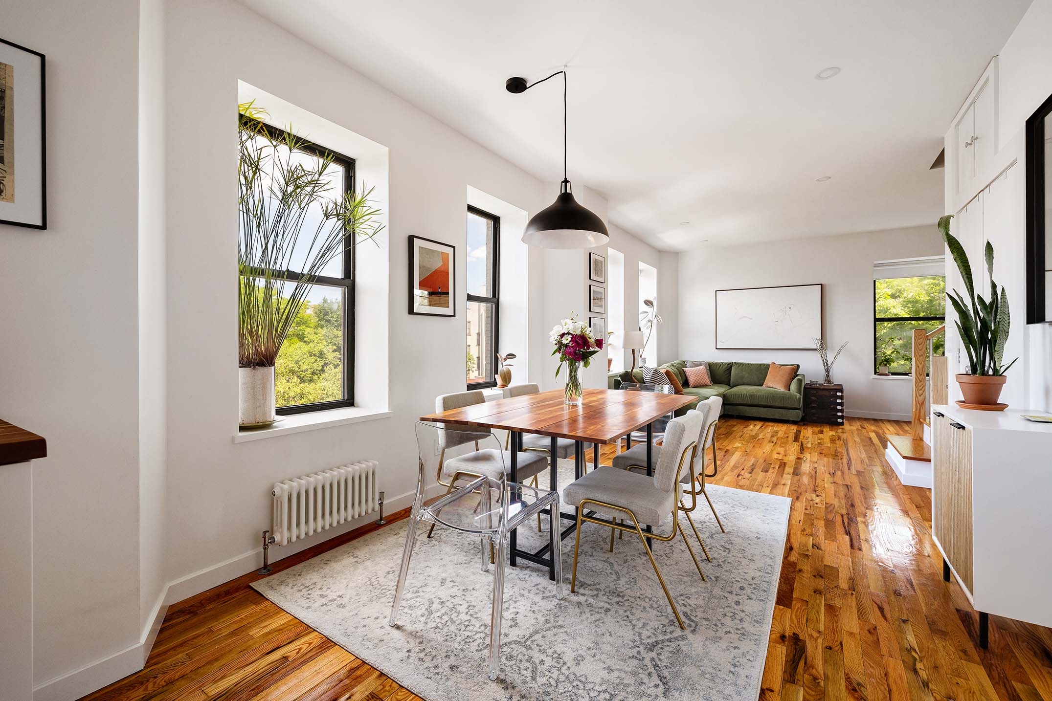 702 East 5th Street, Unit 5E Manhattan, NY 10009 - Photo 2 of 14 a view of a dining room with furniture a chandelier and wooden floor
