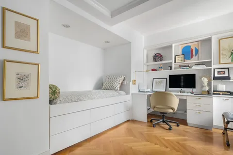 a bedroom with a workspace