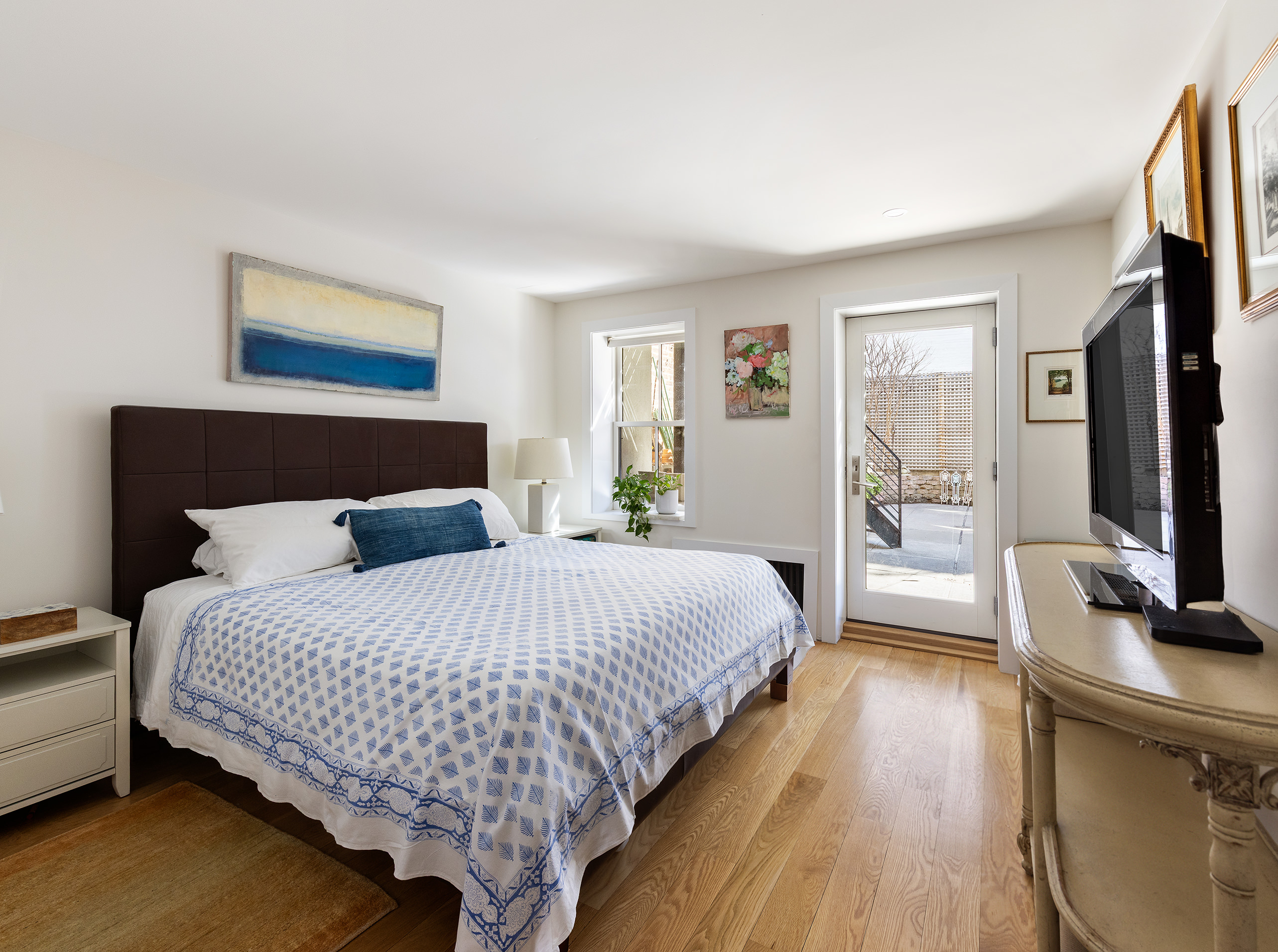 429 Clinton Street, Unit 1 Brooklyn, NY 11231 - Photo 12 of 21 a bedroom with a bed and a flat screen tv