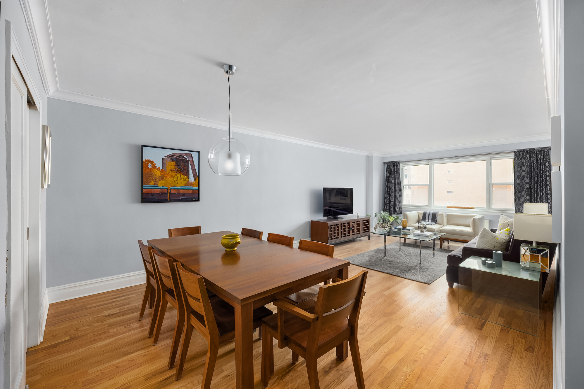 101 West 12th Street, Unit 8N Manhattan, NY 10011 - Photo 5 of 17 a view of a dining room with furniture window and wooden floor