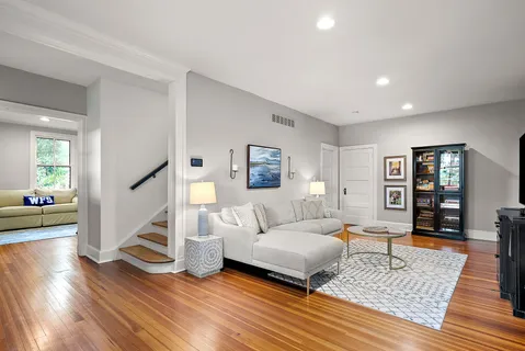 a living room with furniture and wooden floor