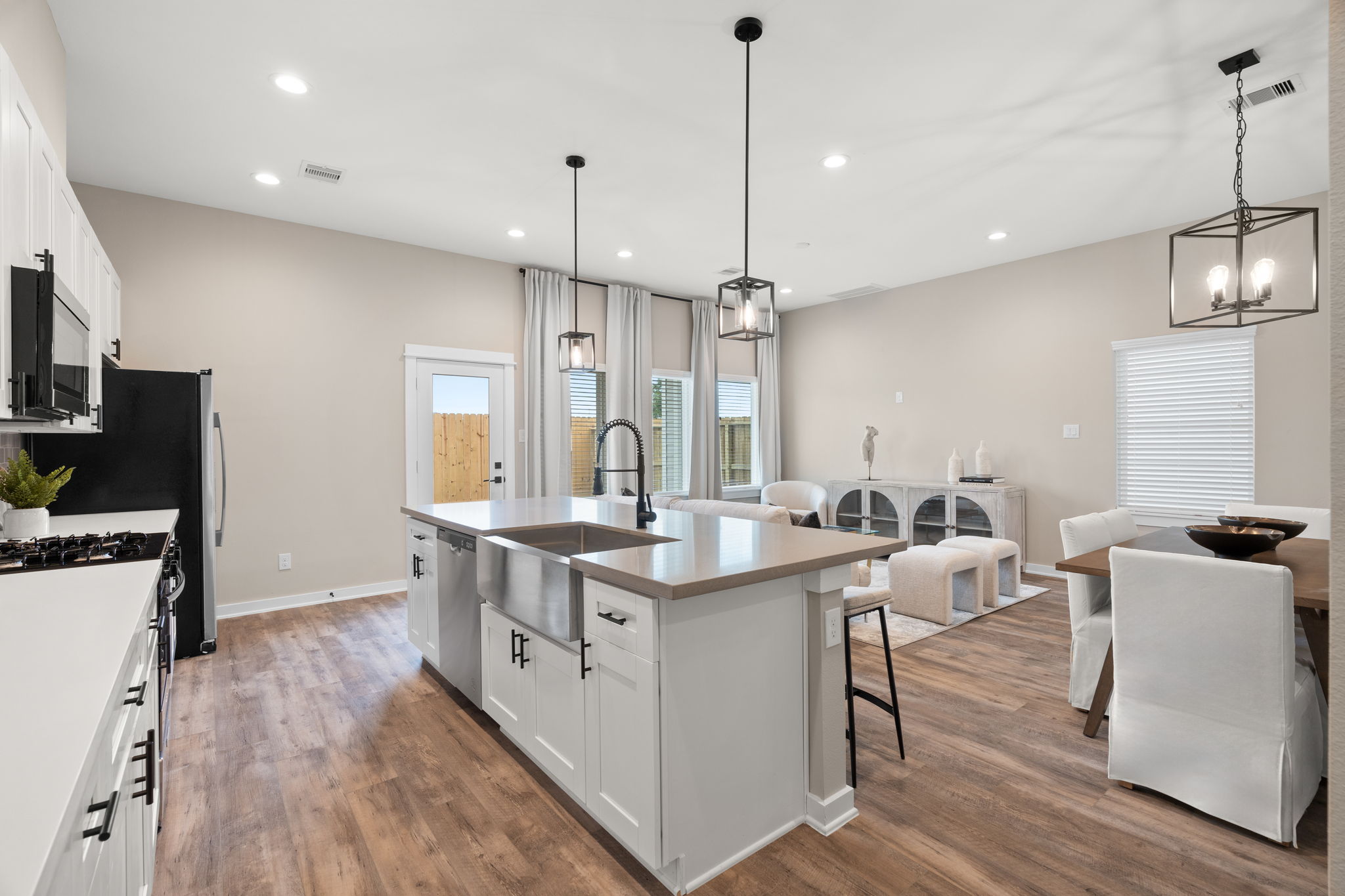 11303 Stonework Grv Lane Houston, TX 77076 - Photo 12 of 39 a kitchen with stainless steel appliances granite countertop a sink a stove a refrigerator and a wooden floor