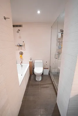 515 East 72nd Street, Unit 22E Manhattan, NY 10021 - Photo 11 of 18 a bathroom with a sink a toilet and shower