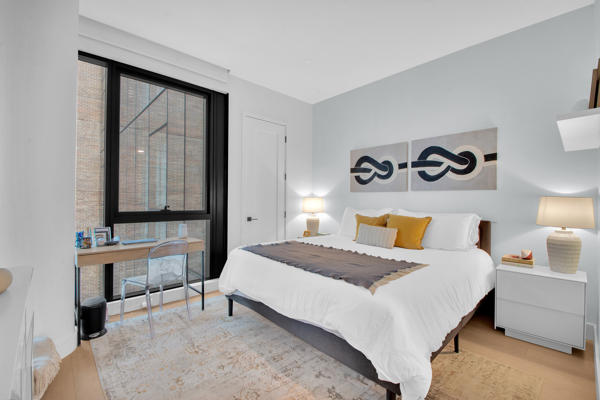 5 Court Square West, Unit 8A Queens, NY 11101 - Photo 4 of 7 a bedroom with a bed and a table