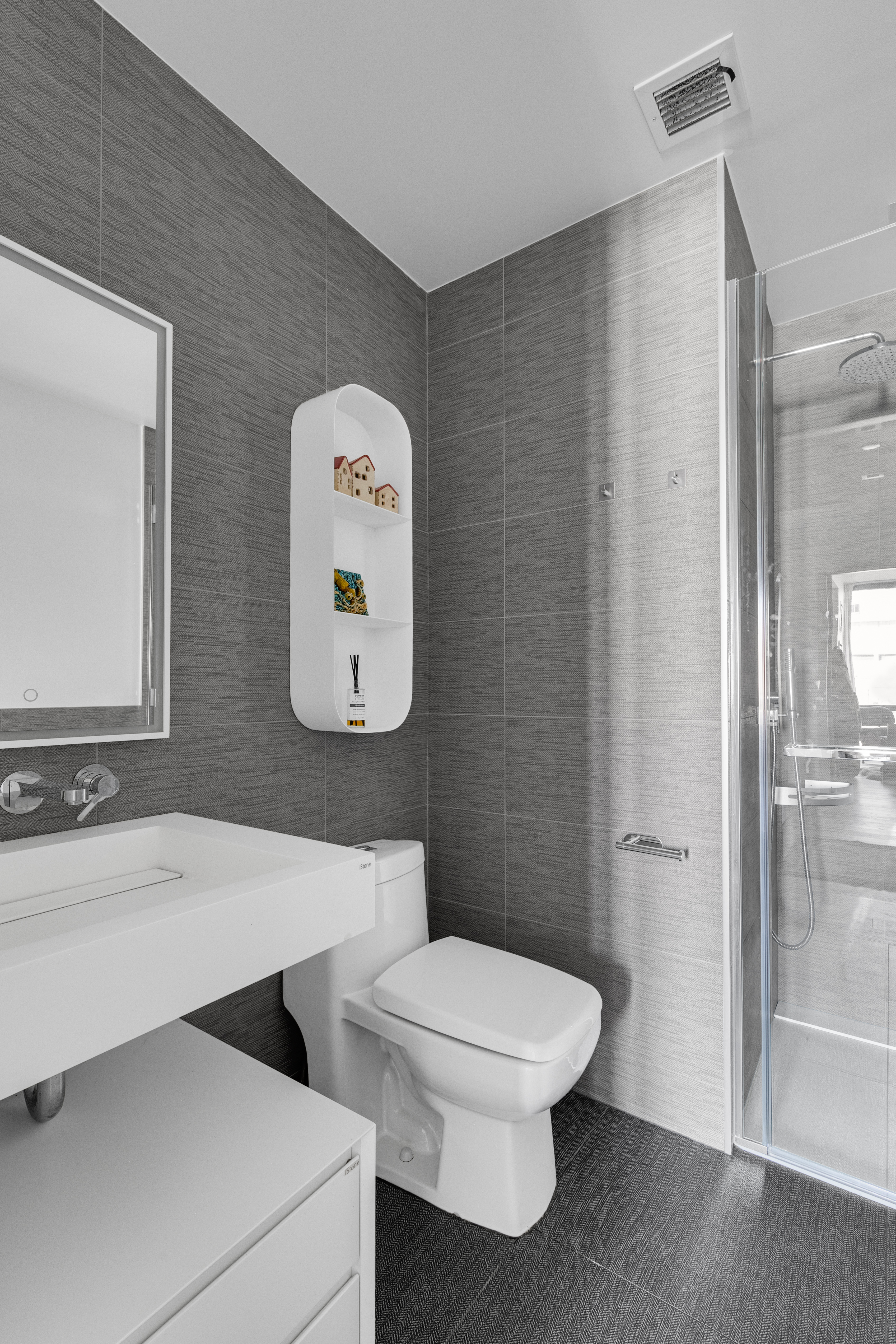 302 East 96th Street, Unit 1103 Manhattan, NY 10128 - Photo 12 of 22 a bathroom with a toilet a sink and mirror