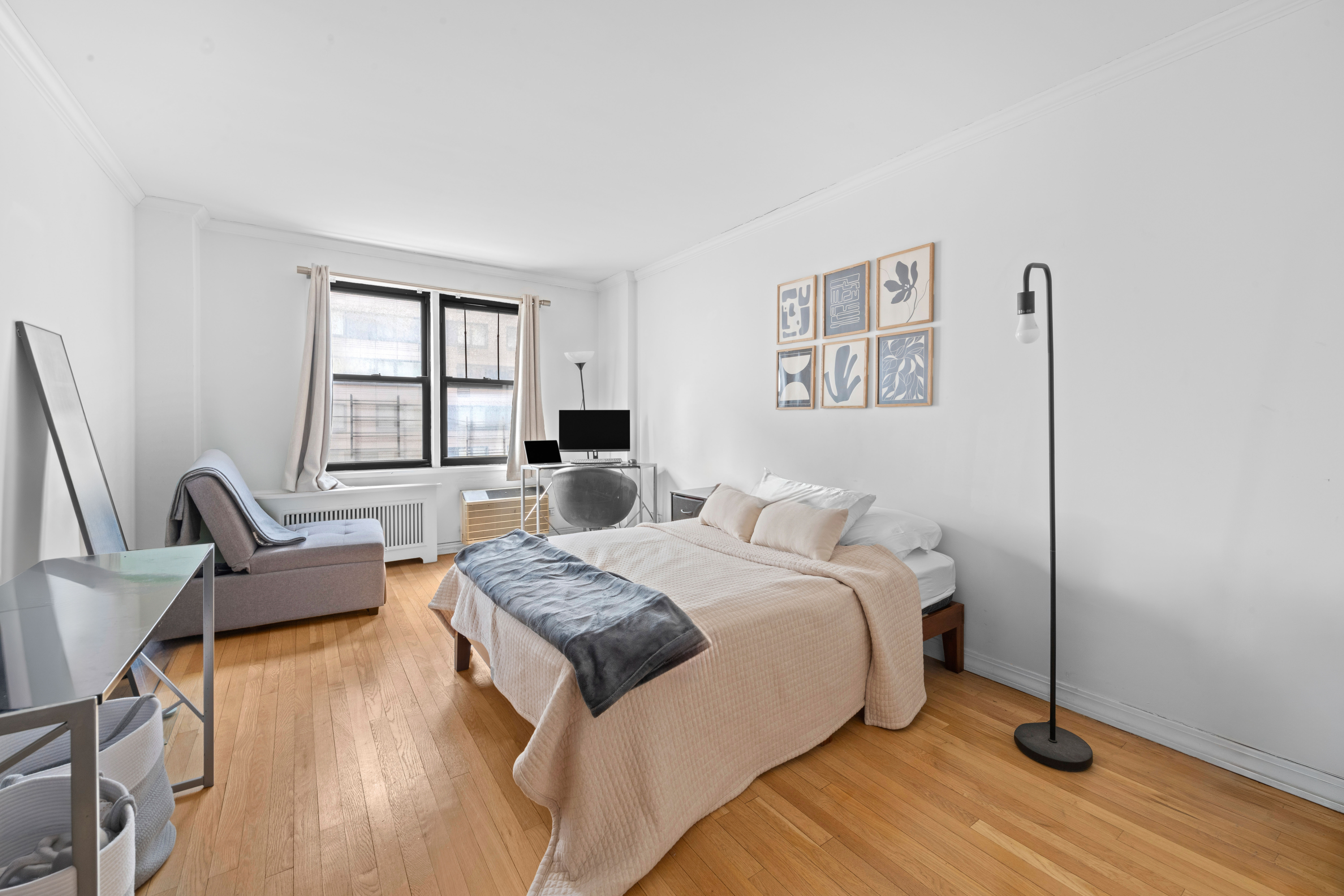 333 East 34th Street, Unit 5E Manhattan, NY 10016 - Photo 2 of 13 a bedroom with a bed and wooden floor