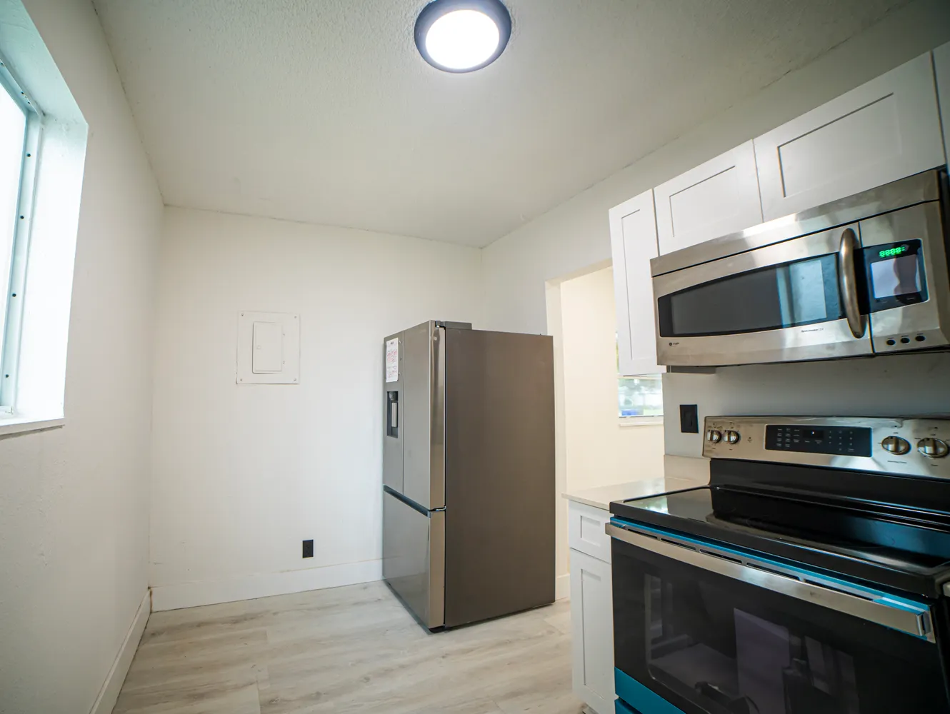 a kitchen with stainless steel appliances a refrigerator stove and microwave
