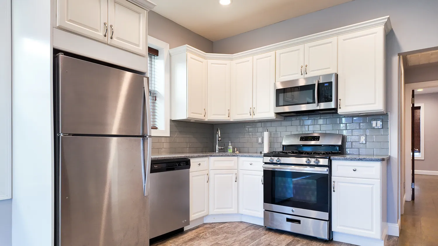 a kitchen with stainless steel appliances a refrigerator stove and microwave