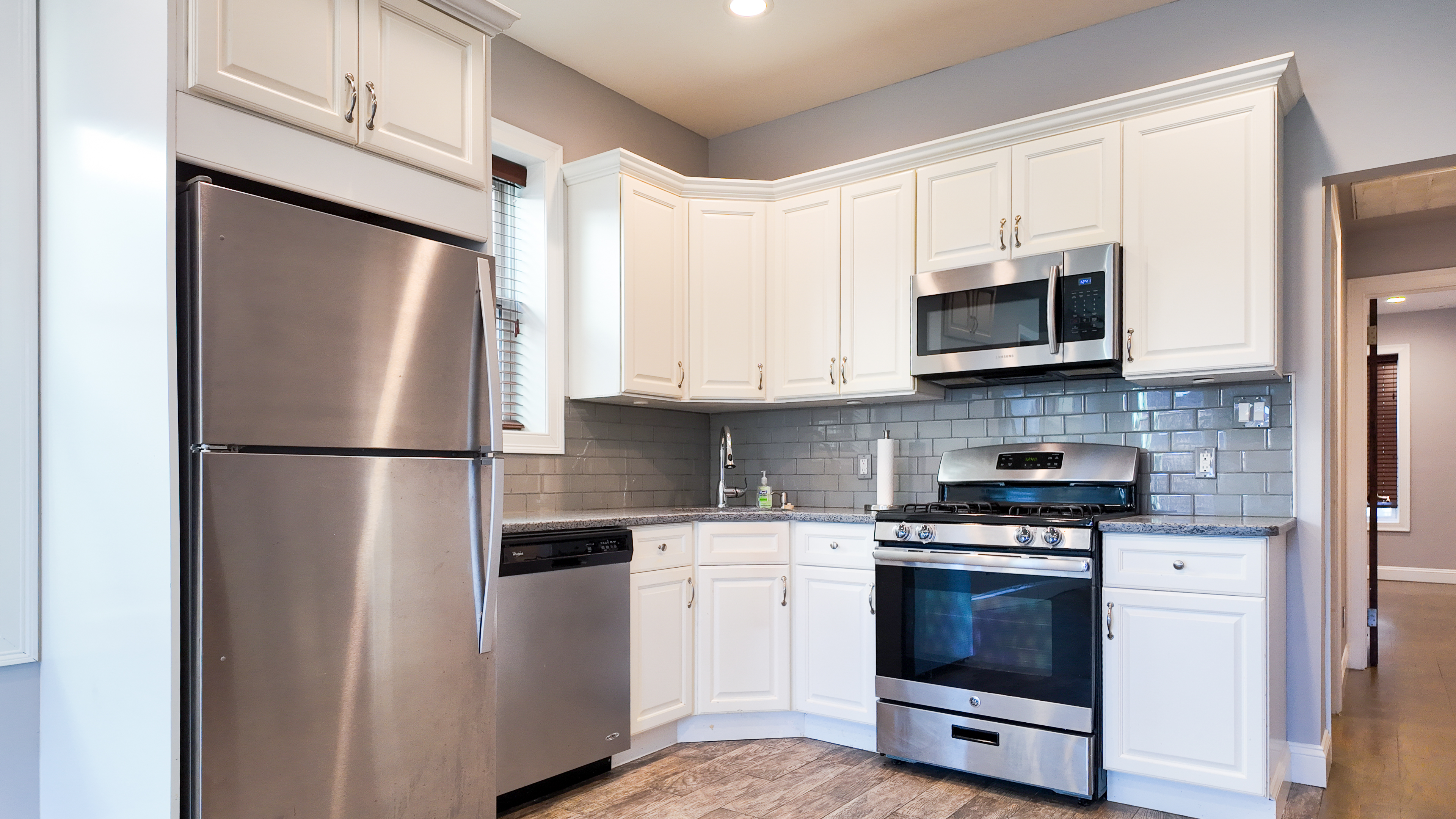 a kitchen with stainless steel appliances a refrigerator stove and microwave