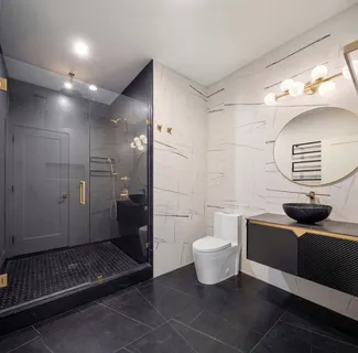 a bathroom with a toilet a sink and mirror