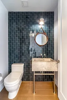 a bathroom with a toilet a sink and a mirror