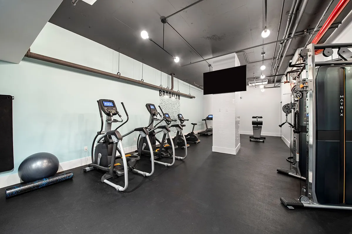 76 Schermerhorn Street, Unit 2C Brooklyn, NY 11201 - Photo 14 of 16 a room with gym equipment and refrigerator