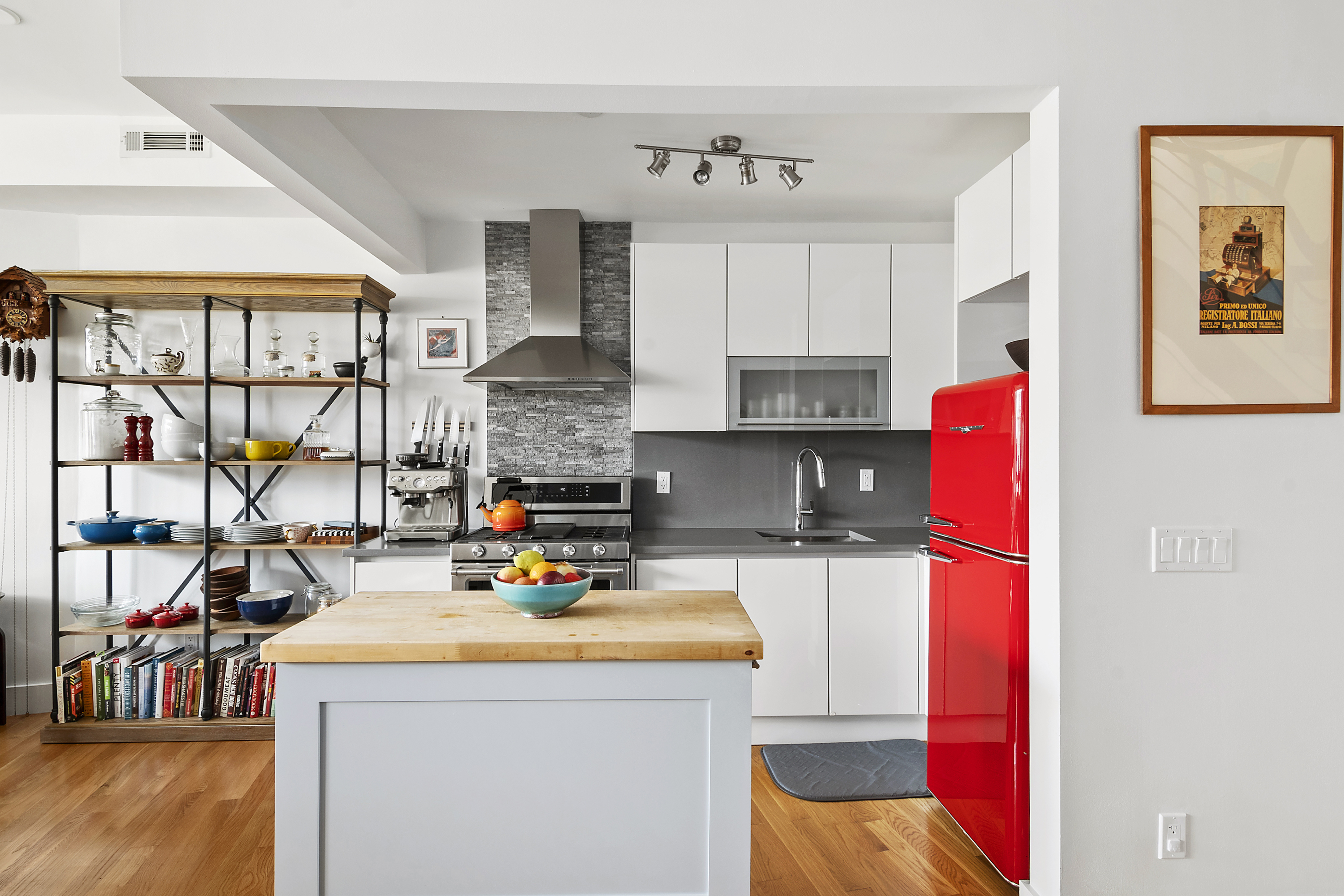 172 Wilson Avenue, Unit PHA Brooklyn, NY 11237 - Photo 2 of 14 a kitchen with stainless steel appliances granite countertop a sink and a refrigerator