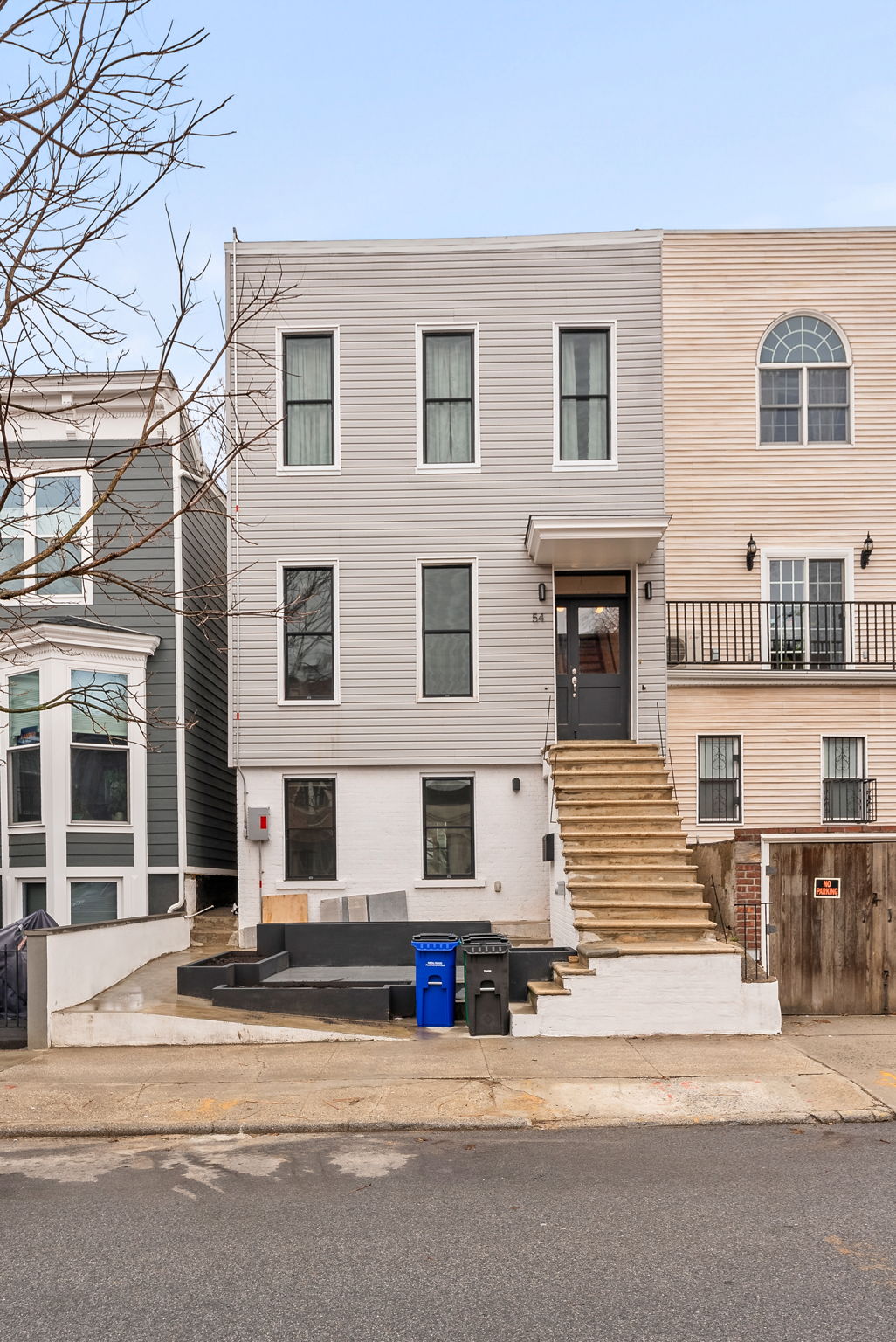 54 East 4th Street, Unit 1 Brooklyn, NY 11218 - Photo 11 of 12 a building that has a street sign on it