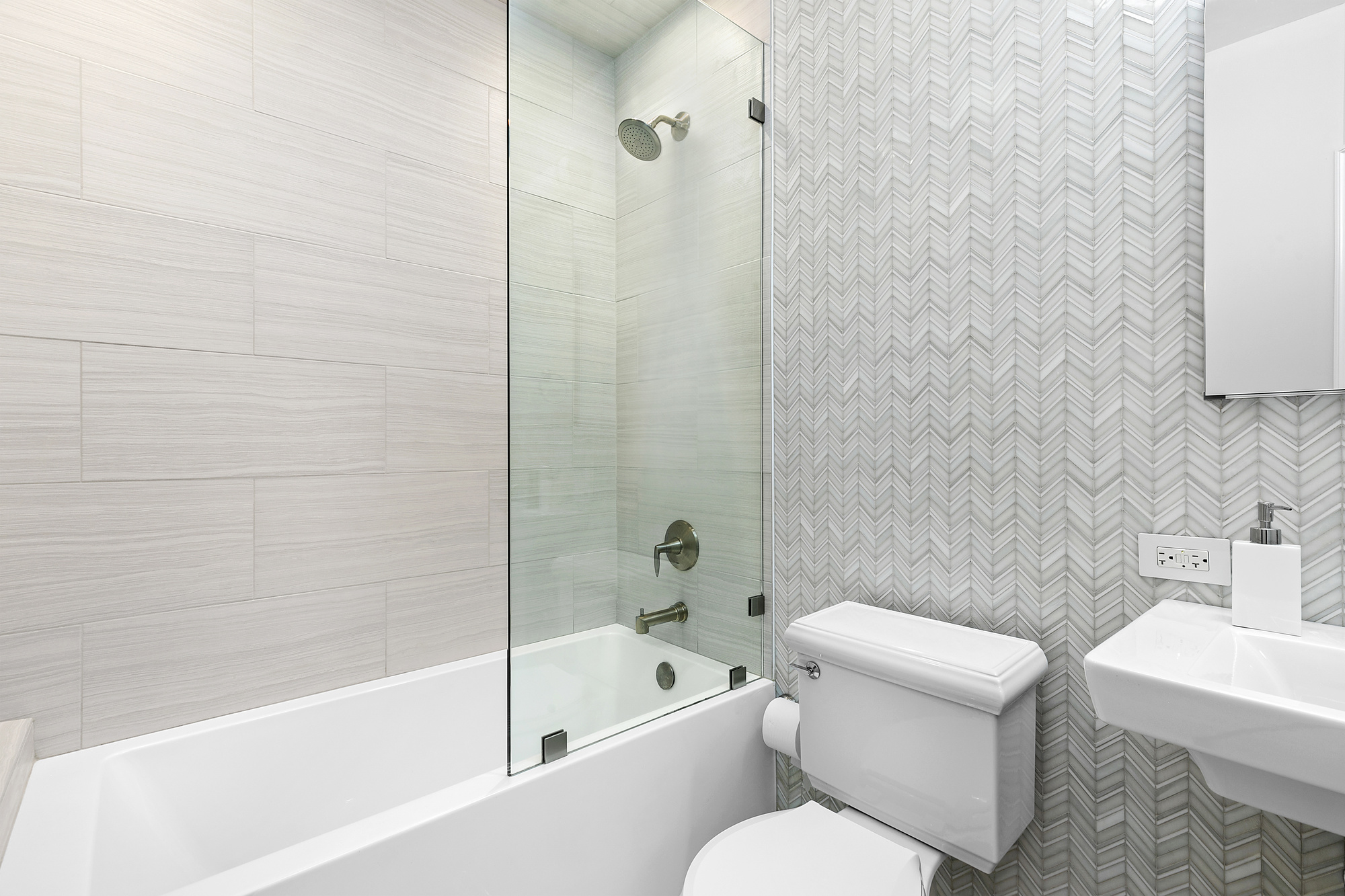 450 West 23rd Street, Unit E Manhattan, NY 10011 - Photo 8 of 12 a white toilet and tub sitting next to a bathroom sink